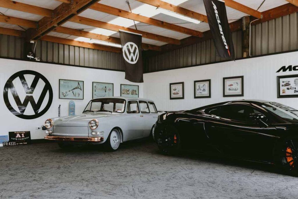 Mad Sounds Automotive showroom with luxury and classic cars displayed on durable commercial flooring in a high-traffic retail space.